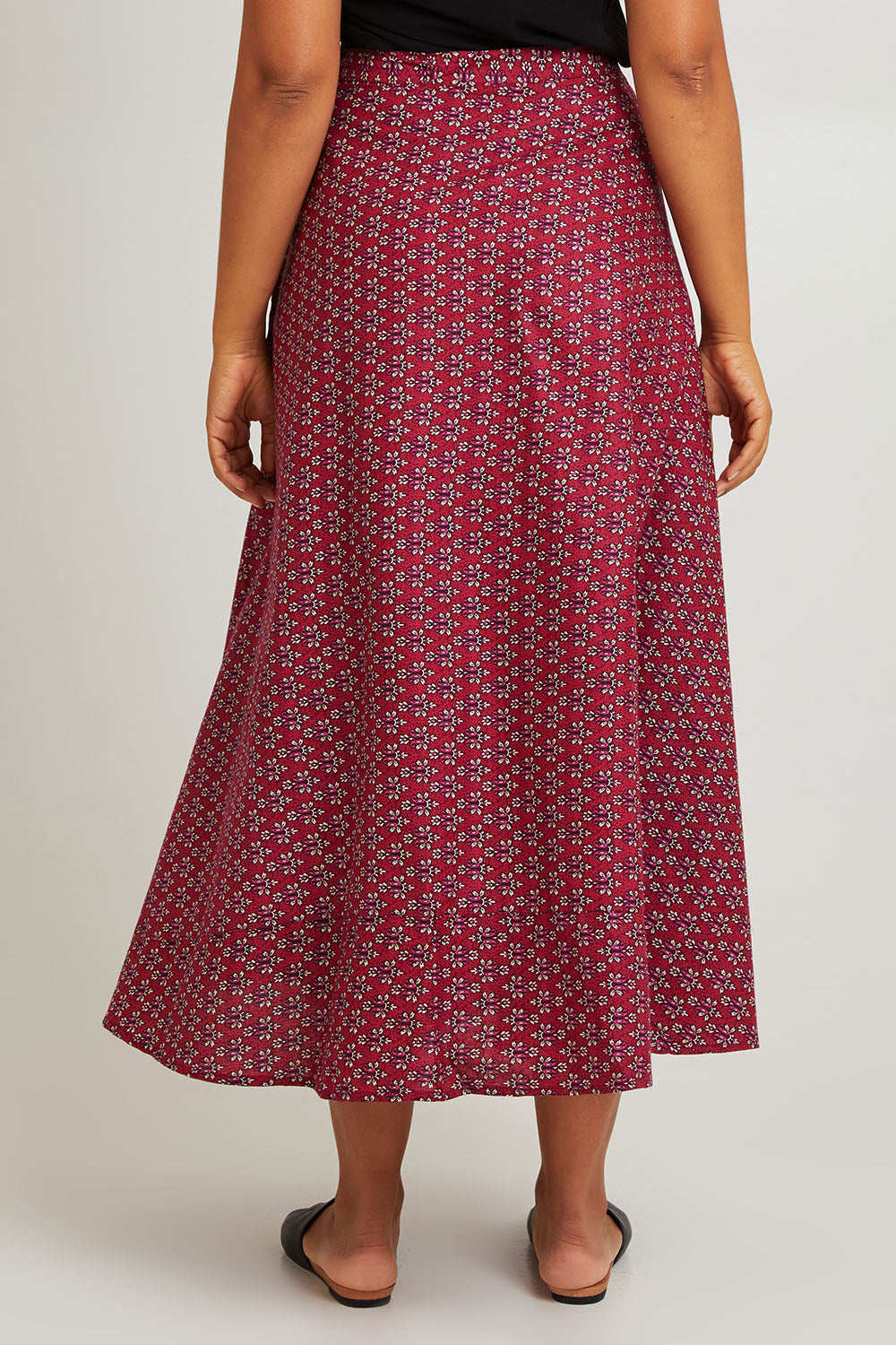 Model Olivia wearing size OneSize of the Grace Cotton Wrap Skirt in colour Corfu (Red), from the back