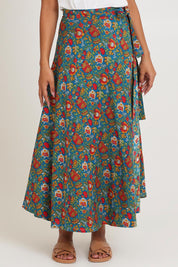 Model Ziara wearing size OneSize of the Grace Cotton Wrap Skirt in colour Valla, from the front, cropped image