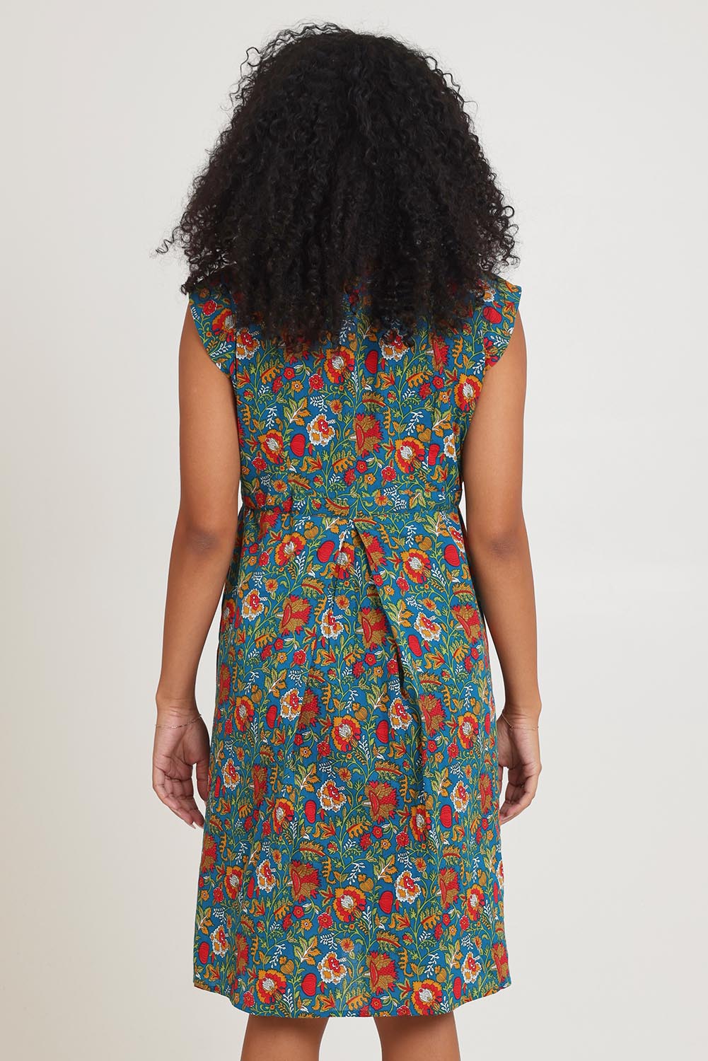 Model Ziara wearing size S of the Chrissie Cotton Tunic Dress in colour Valla, from the back