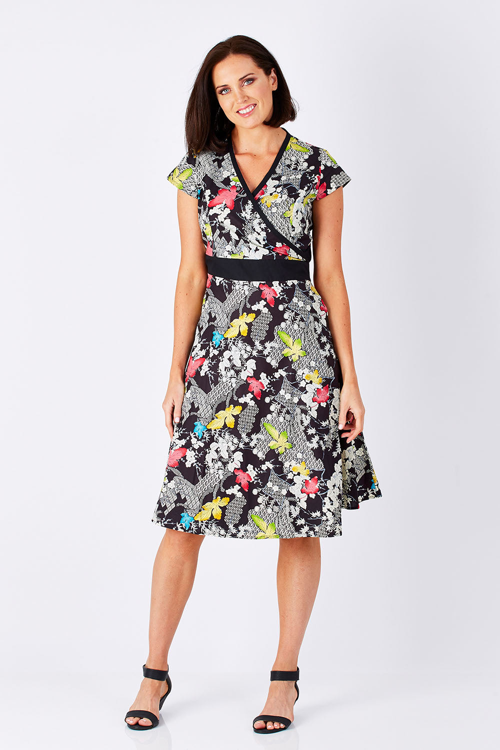 Model Perrie wearing size S of the Leela Print Cotton Wrap Dress in colour Nikko (Black), from the front, showing the whole outfit