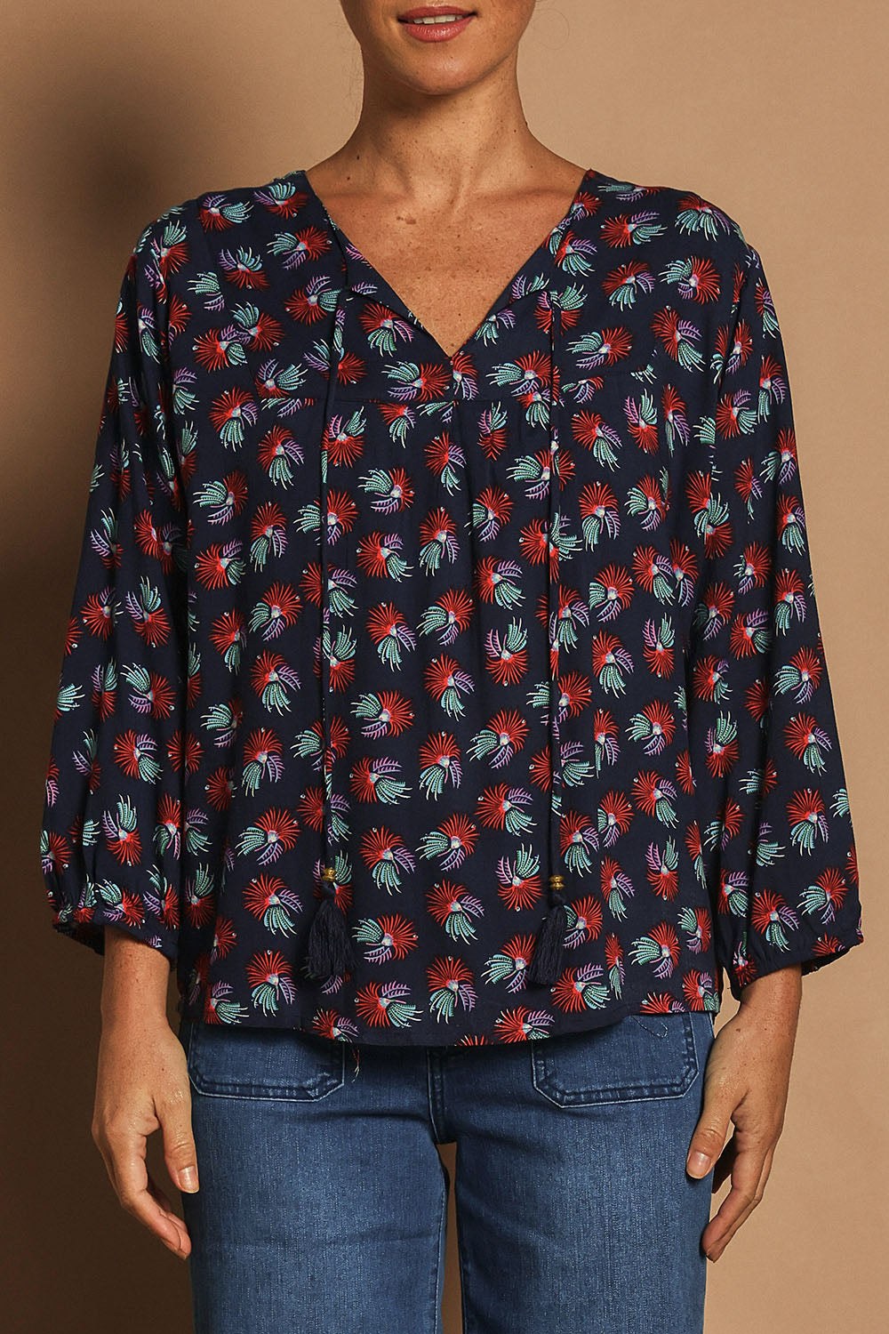 Model Katie wearing the Palais Top in colour Soho (Blue), from the front, cropped image