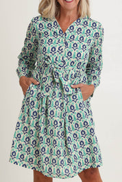 Model Sandy wearing size S of the Heidi Dress in colour Ikata, from the front, cropped image