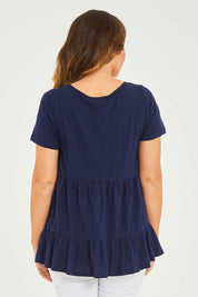 Model Georgia wearing size 10 of the Harper Layered Top in colour Navy (Blue), from the back