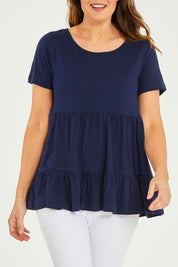 Model Georgia wearing size 10 of the Harper Layered Top in colour Navy (Blue), from the front, cropped image