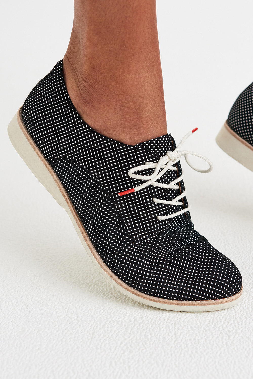 A model wearing the Derby Dream Flat in colour Blackspot (Black), from the front, cropped image