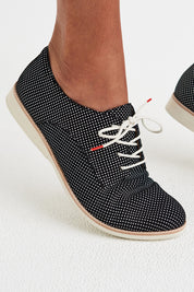 A model wearing the Derby Dream Flat in colour Blackspot (Black), from the front, cropped image