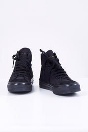 A model wearing size 38 of the Ranger High Top Sneaker in colour Blkstealth (Black), from the front, showing the whole outfit