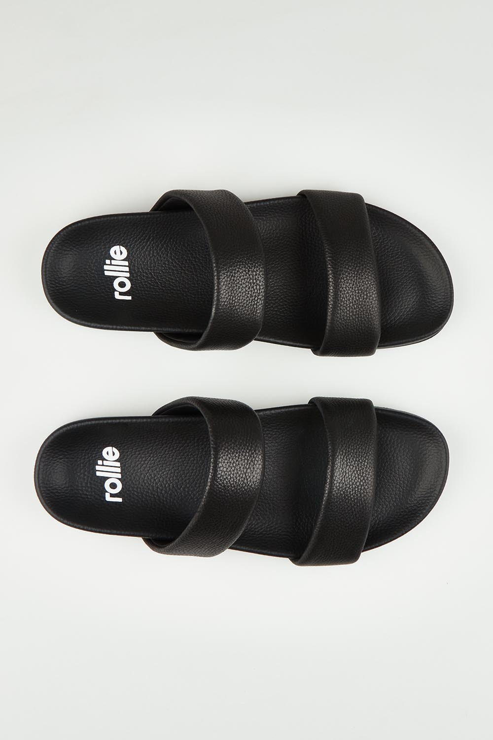 A model wearing size 37 of the Tide Leather Double Strap Slide in colour Black (Black), from the front, showing the whole outfit
