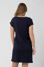 A model wearing the Roxie Nursing Dress in colour Navy (Blue), from the back