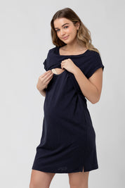 A model wearing the Roxie Nursing Dress in colour Navy (Blue), from the front, cropped image
