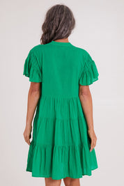 Model Luisa wearing size S of the Abigail Dress in colour Emerald (Green), from the back