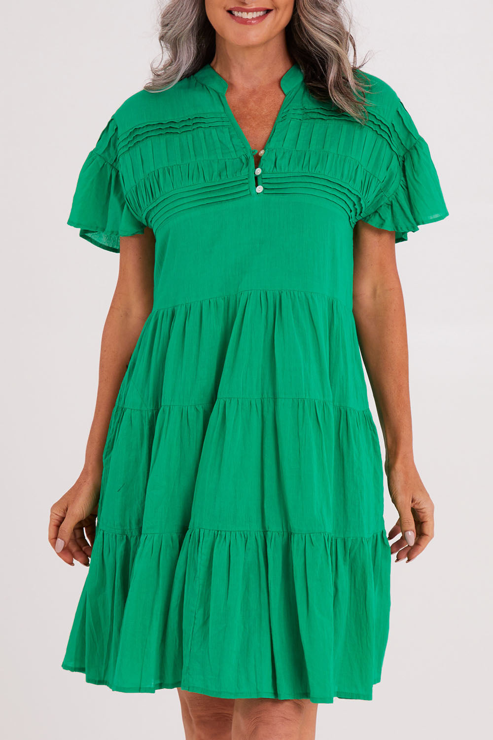 Model Luisa wearing size S of the Abigail Dress in colour Emerald (Green), from the front, cropped image