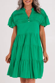 Model Luisa wearing size S of the Abigail Dress in colour Emerald (Green), from the front, cropped image