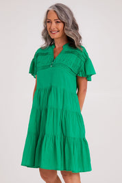 Model Luisa wearing size S of the Abigail Dress in colour Emerald (Green), from the front, cropped image