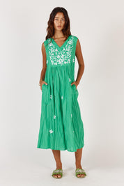 A model wearing the Andaman Cotton Midi Dress in colour Emerald (Green), from the front, showing the whole outfit