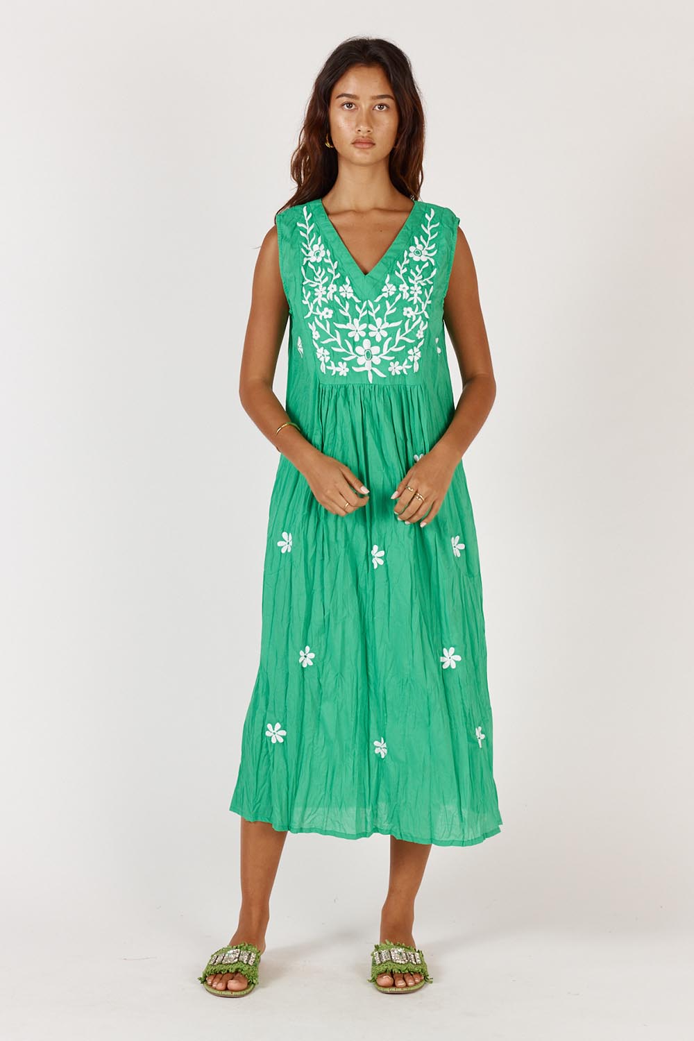 A model wearing the Andaman Cotton Midi Dress in colour Emerald (Green), from the front, showing the whole outfit