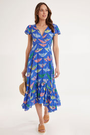 Model Madeline wearing size S of the Birds Of Surfers Wrap Dress in colour Blue (Blue), from the front, showing the whole outfit