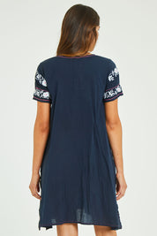 Model Madeline wearing size S of the Charlotte Dress in colour Navy (Blue), from the back