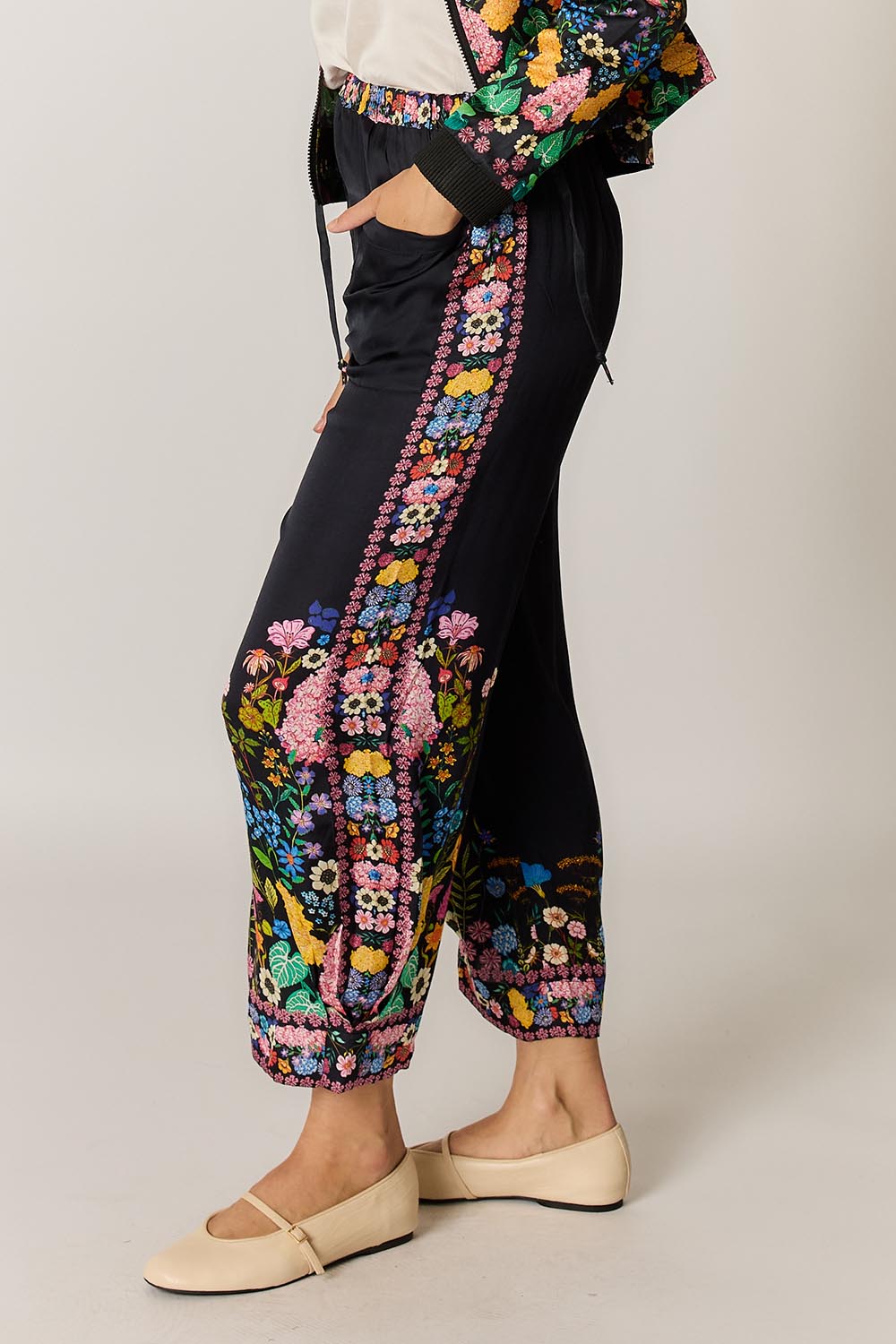 Model Genericm wearing size sample of the Delicia Pant – Black in colour Black, from an angle