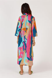 A model wearing the Lotus Bloom Cotton Midi Dress in colour Print, from the back