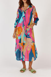 A model wearing the Lotus Bloom Cotton Midi Dress in colour Print, from the front, cropped image