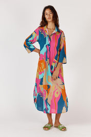 A model wearing the Lotus Bloom Cotton Midi Dress in colour Print, from the front, showing the whole outfit