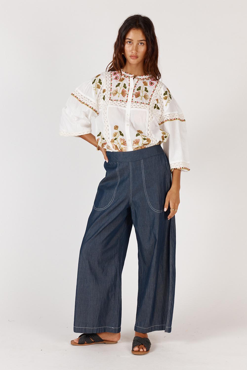 A model wearing the Monfils Cotton Top in colour White (White), from the front, showing the whole outfit
