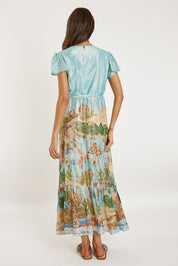 A model wearing the Montpellier Wrap Dress in colour Print (Blue), from the back