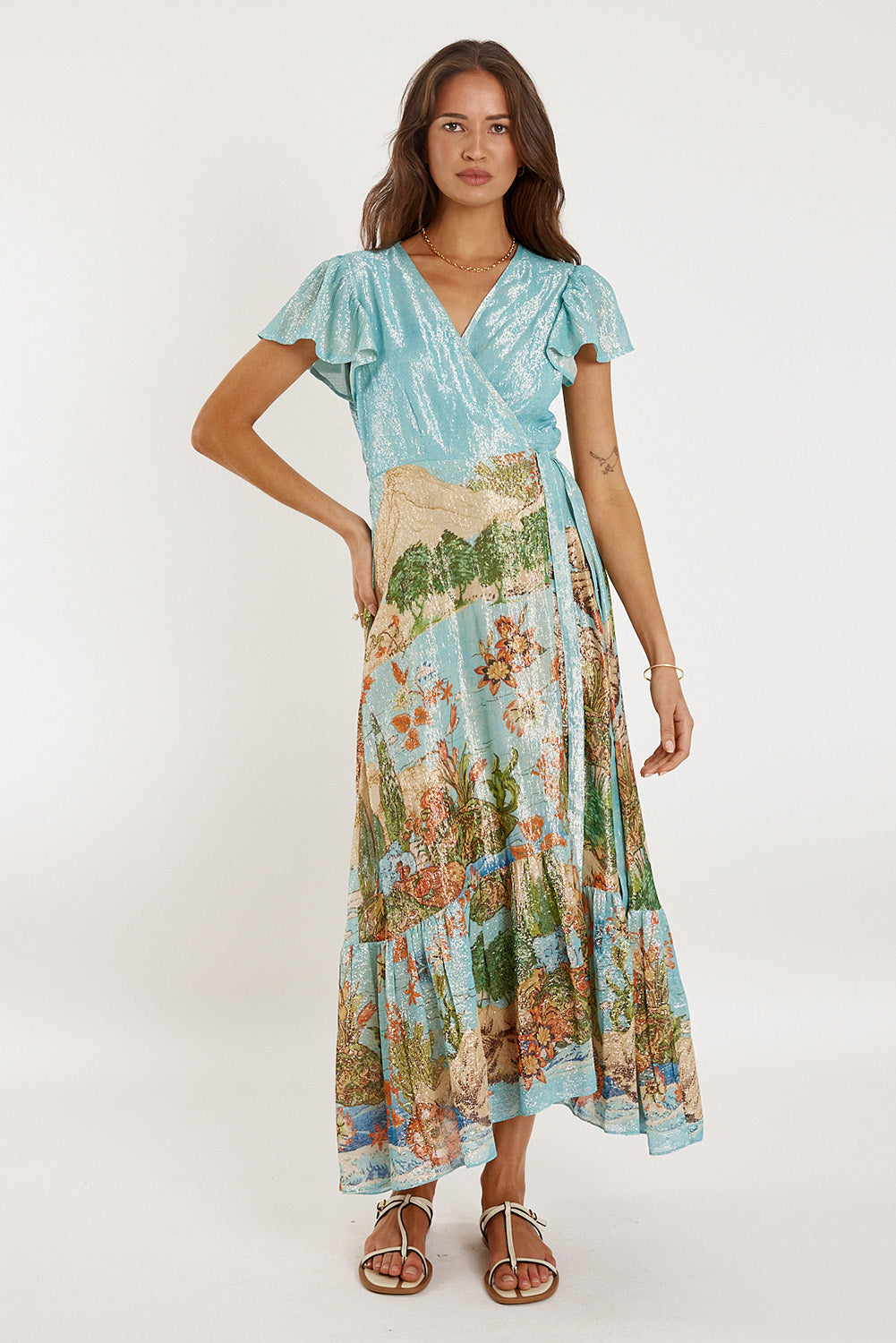 A model wearing the Montpellier Wrap Dress in colour Print (Blue), from the front, showing the whole outfit