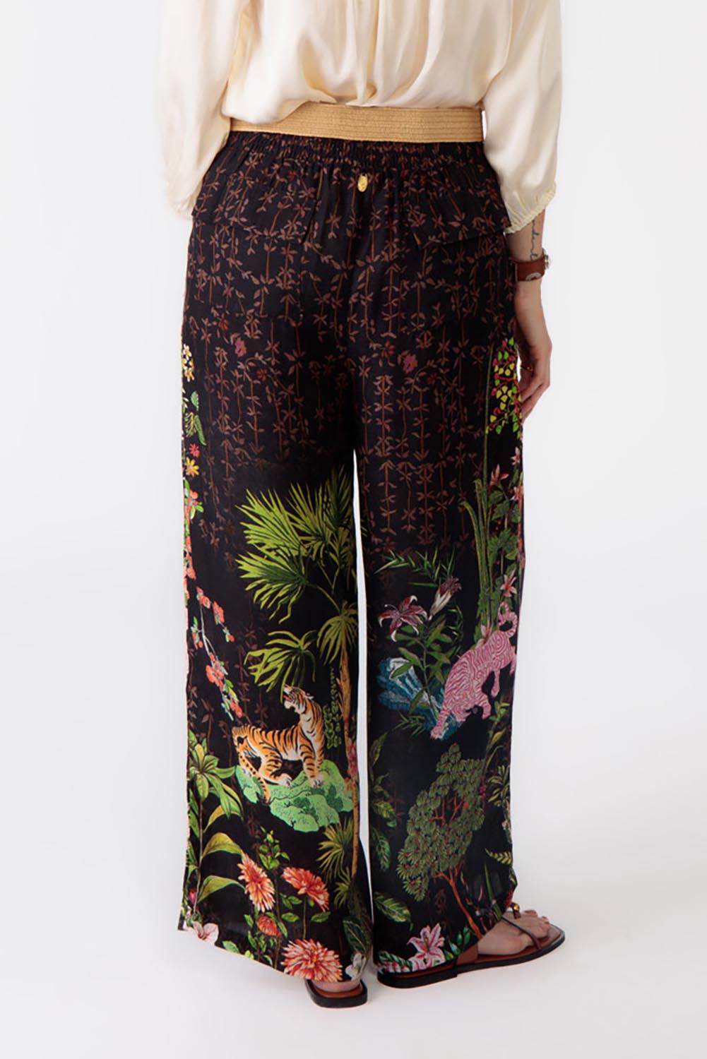 A model wearing the Nouveau Pant in colour Black (Black), from the back