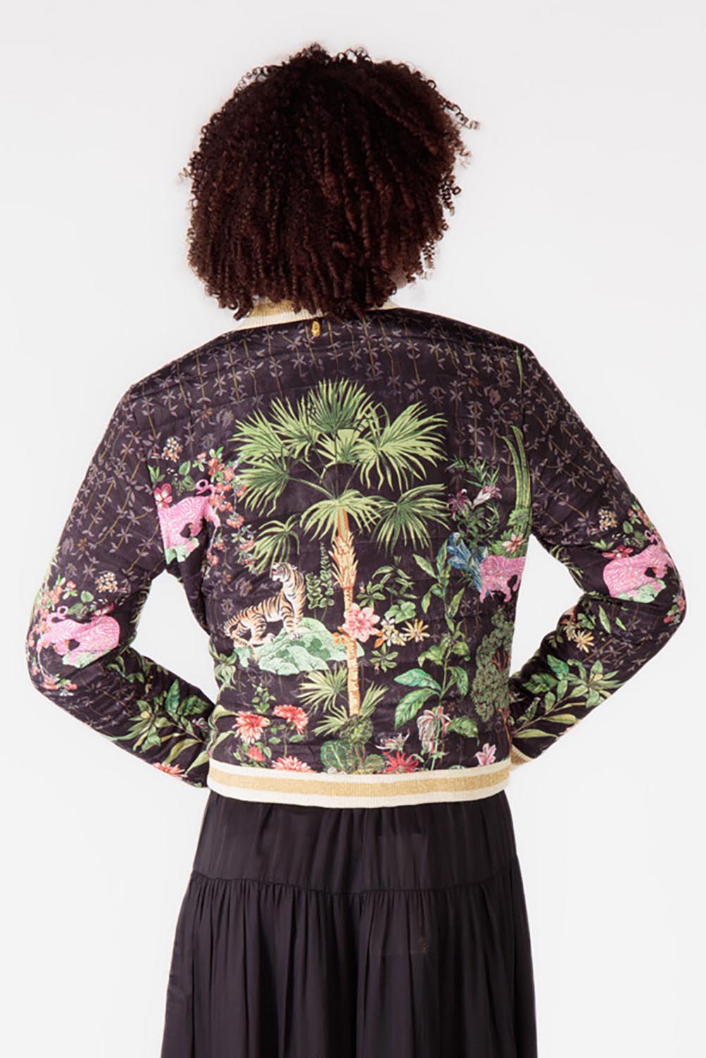 A model wearing the Nouveau Quilted Jacket in colour Black (Black), from the back