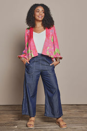 Model Ziara wearing size S of the Pula Pant in colour Denim (Blue), from the front, showing the whole outfit