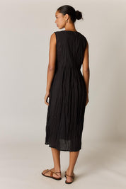 Model Genericm wearing size sample of the Sasha Sundress – Black in colour Black, from the front