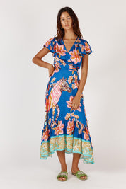 A model wearing the Tango Wrap Dress in colour Print (Blue), from the front, showing the whole outfit