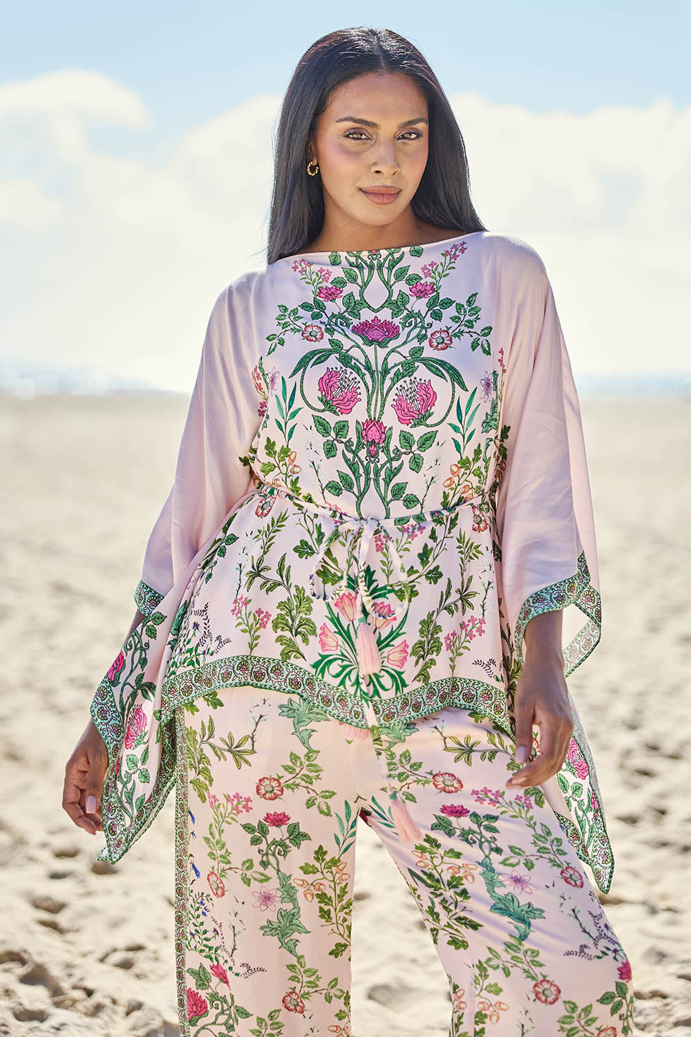 Model Eshan wearing size 10 of the Tatiana Poncho – Pink in colour Pink, from the front