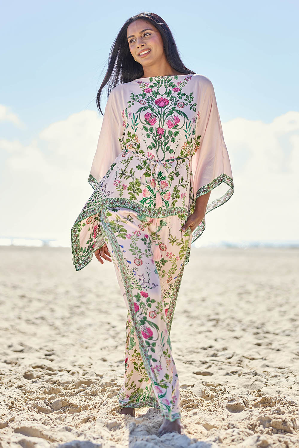 Model Eshan wearing size 10 of the Tatiana Poncho – Pink in colour Pink, from the front