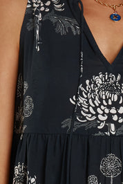 A model wearing the Waratah Cotton Dress in colour Print (Black), from the front, cropped image