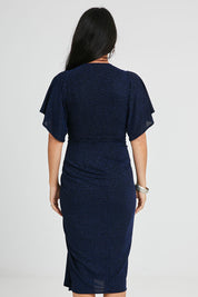 Model Katie wearing size 10 of the Emporium Dress in colour Sapphire (Blue), from the back