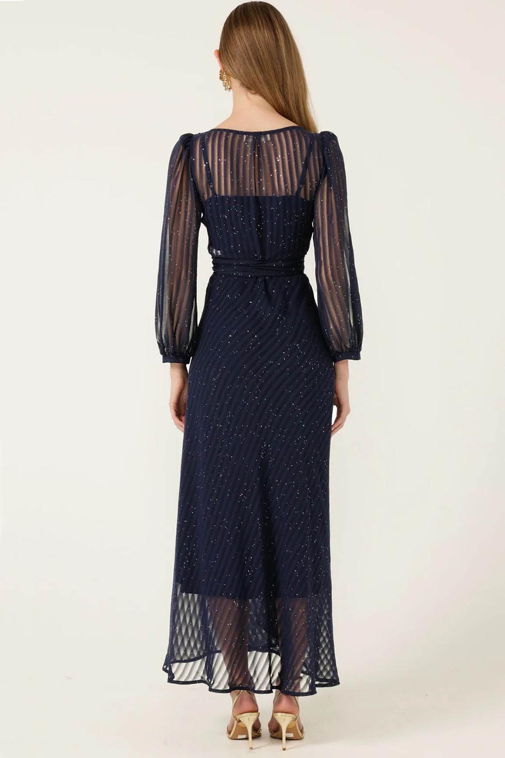 A model wearing the Sierra Wrap Dress in colour Navysparkl (Blue), from the back