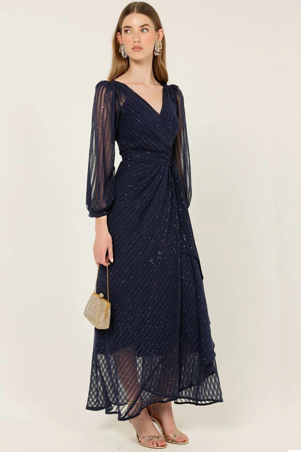A model wearing the Sierra Wrap Dress in colour Navysparkl (Blue), from the front, showing the whole outfit