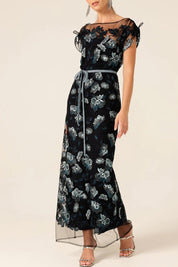A model wearing the Love Potion Maxi Dress in colour Midnight (Blue), from the front, cropped image