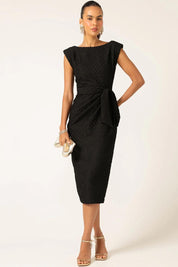 A model wearing the Celestial Dress in colour Black (Black), from the front, showing the whole outfit