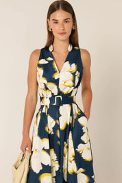 A model wearing the Simone Cotton Dress in colour Navy (Blue), from the front, cropped image