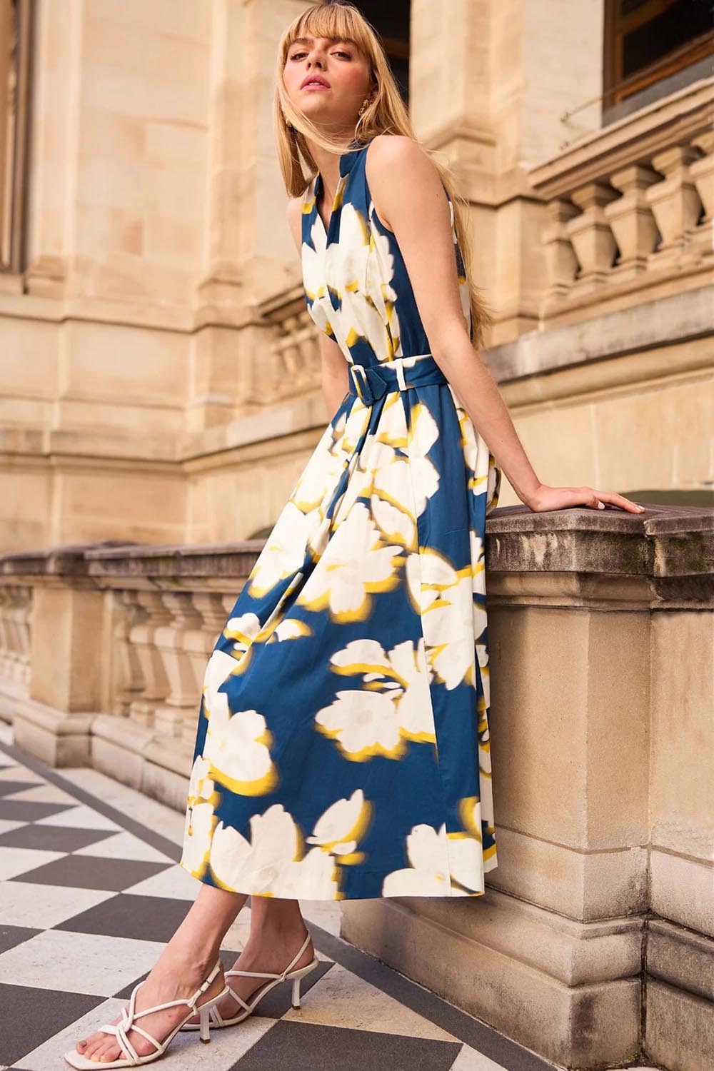 A model wearing the Simone Cotton Dress in colour Navy (Blue), from the front, showing the whole outfit