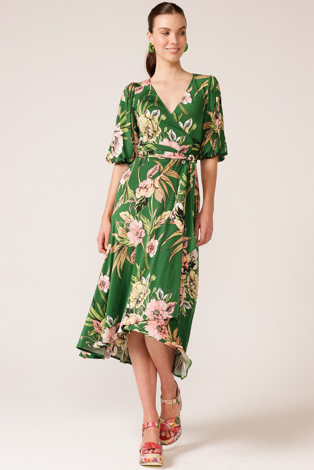 A model wearing the Chambord Wrap Midi Dress in colour Green (Green), from the front, showing the whole outfit