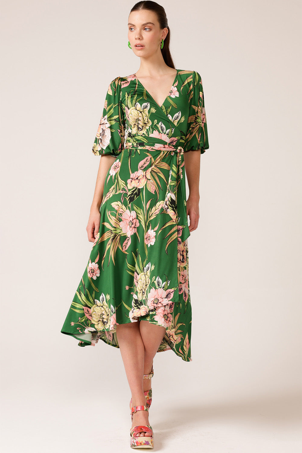 A model wearing the Chambord Wrap Midi Dress in colour Green (Green), from the front, showing the whole outfit