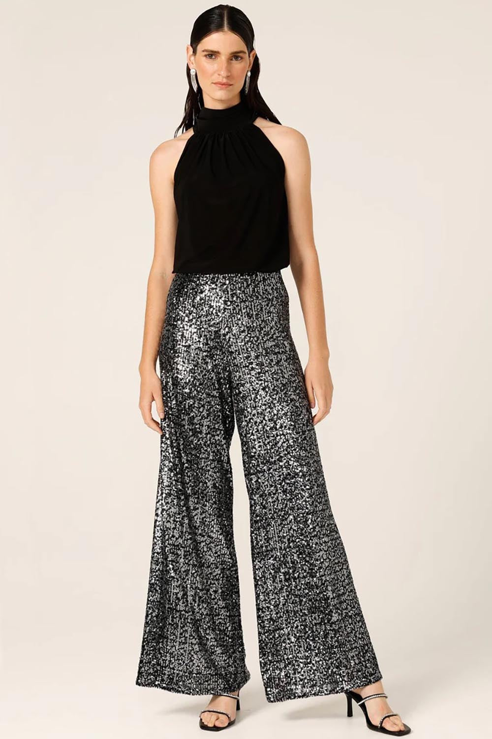 A model wearing the Sequin Palazzo Pants in colour Blksilver (Black), from the front, showing the whole outfit