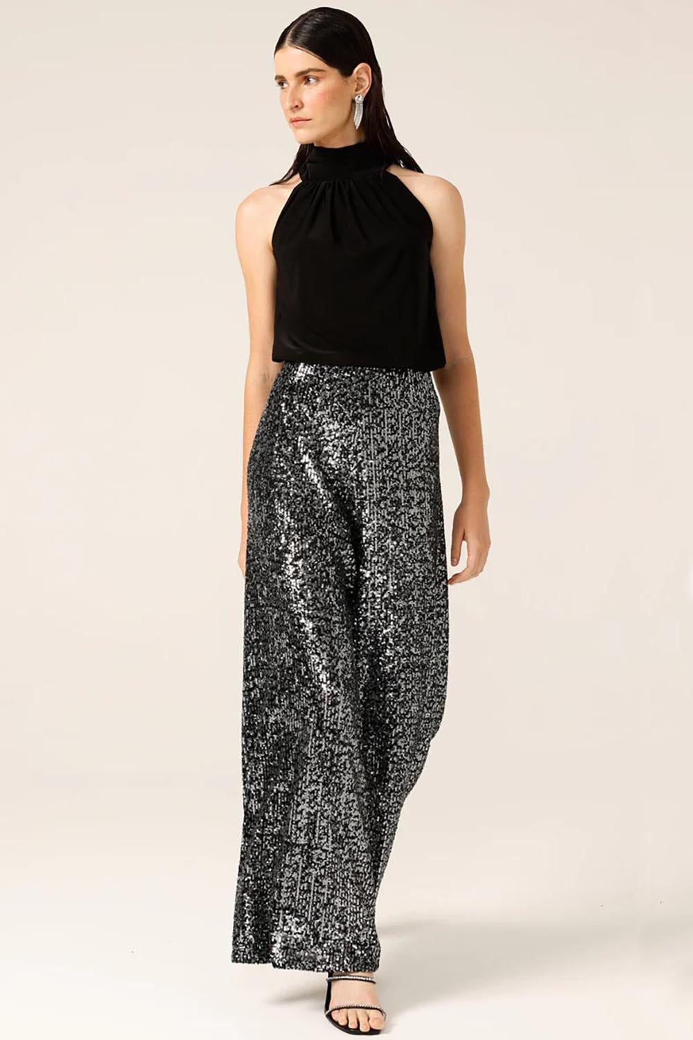 A model wearing the Sequin Palazzo Pants in colour Blksilver (Black), from the front, showing the whole outfit