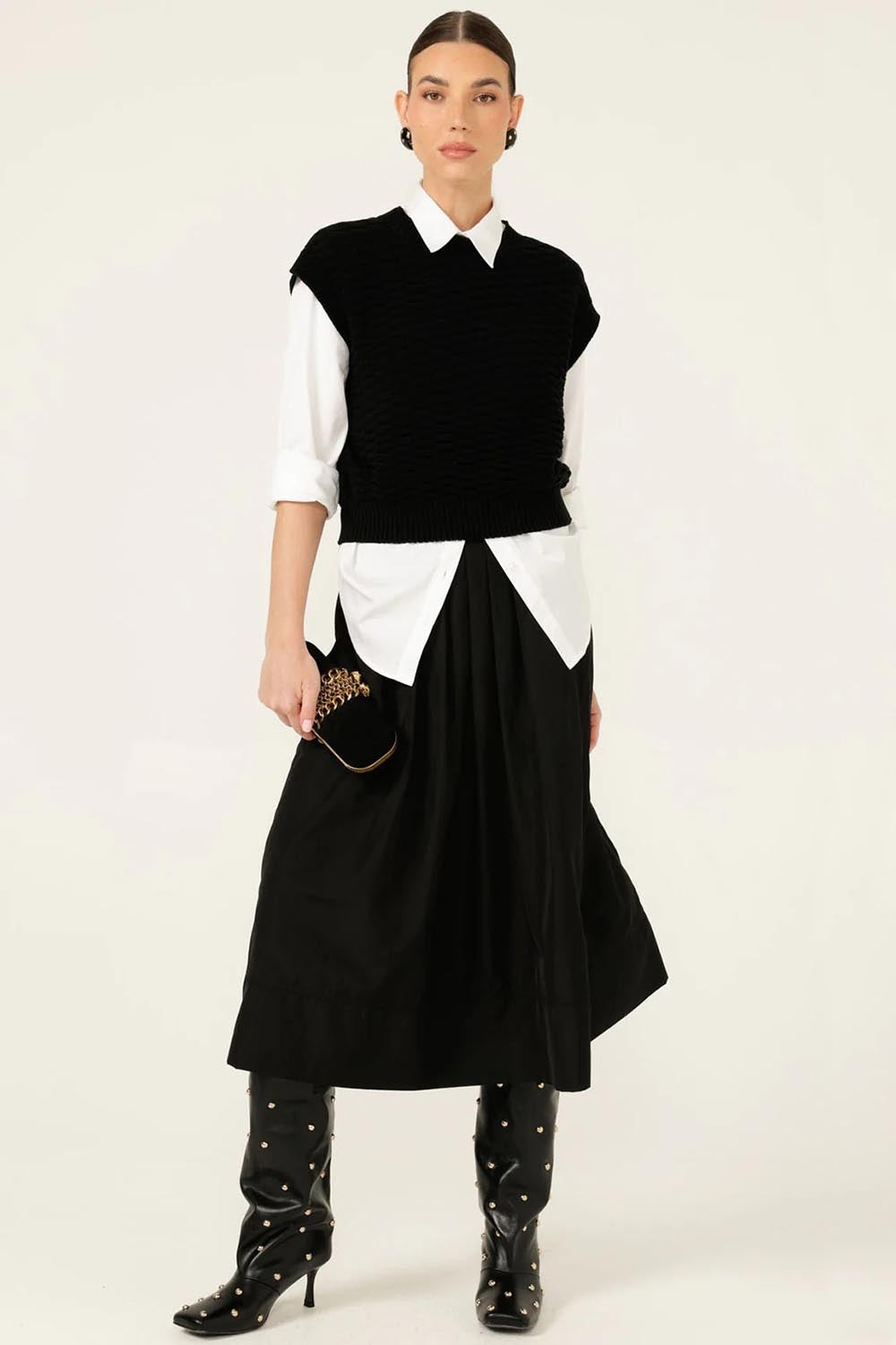 A model wearing the Pleated Ain colourLine Skirt - Black (Black), from the front, showing the whole outfit