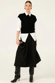 A model wearing the Pleated Ain colourLine Skirt - Black (Black), from the front, showing the whole outfit